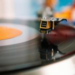 retro turntable playing vinyl disc in living room